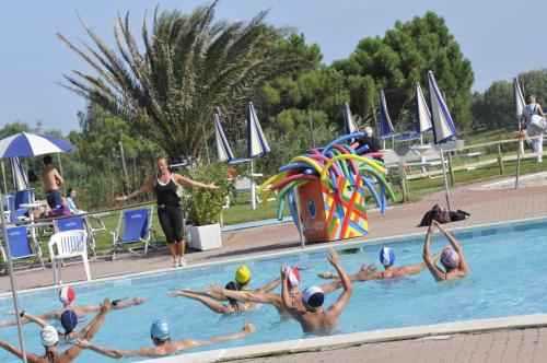 a group of people swimming in a swimming pool at Villa Fortuna in Palazzo Vianello