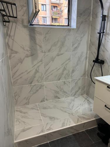 a bathroom with a marble shower with a window at Privât Room In private residence with free parking, 1 minute from tramway, 9 minutes from de center, accessible all transports in Nice