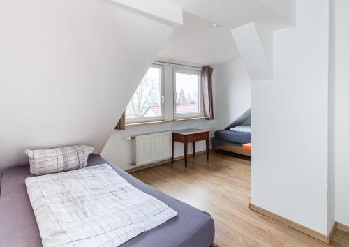 a small bedroom with a bed and a window at Pension für Monteure in Leipzig in Leipzig