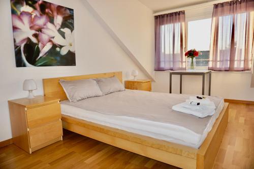 a bedroom with a bed with a teddy bear on it at 3,5-Room Sunrise Terrace Haven FR-32 in Wallisellen