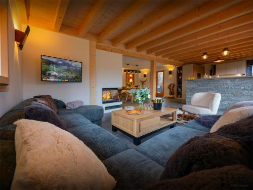 a living room with a couch and a table at Chalet Evonyx - OVO Network in Samoëns