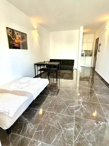 a room with a bed and a table in it at Flat Luxuous Praia da Oura in Albufeira
