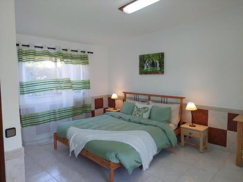 a bedroom with a bed and a window at Villa Lucia, Olhos D'Agua, Albufeira in Albufeira