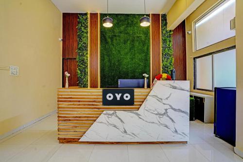 an office with a reception desk with a vox sign on it at Collection O Sunset Residency in Mumbai