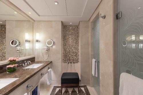 a bathroom with a sink and a shower at Raffles Makkah Palace in Makkah