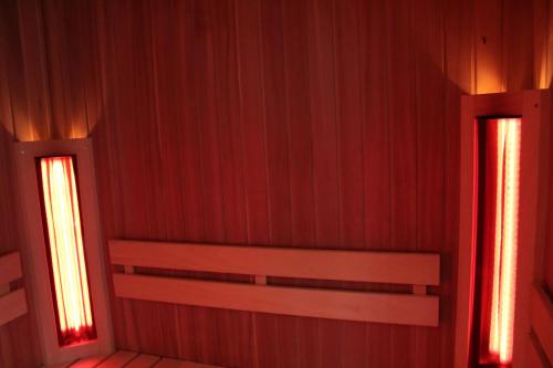 an empty room with red walls and two windows at Vakantiehuis Ardennen Entre Ciel Et Forêt in Houyet