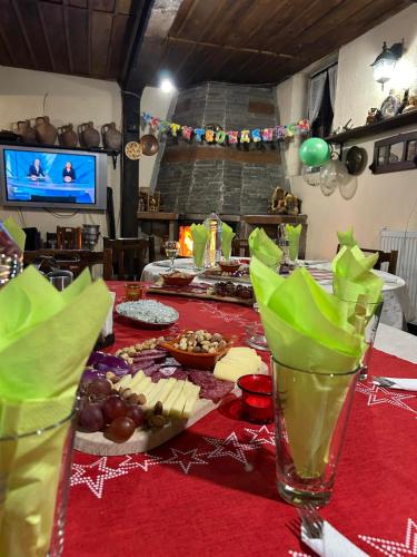 a table with a red table cloth with food on it at Guest House Popov in Marchevo
