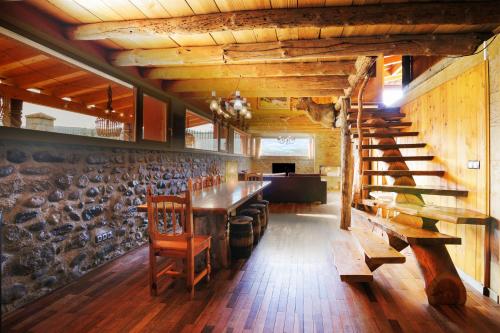 a dining room with a table and wooden walls at Can Ricart in Puigcerdà
