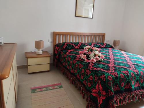 a bedroom with a bed with a flower arrangement on it at Tra i Parchi in Pescina