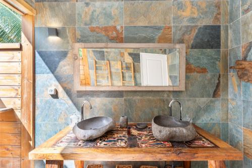 a bathroom with two sinks on top of a stove at "Le Pavillon" - Résidence Blue Palm - St François - Guadeloupe in Saint-François