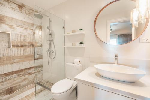 a bathroom with a sink and a toilet and a mirror at Magical apartment in Fundadores in Punta Cana