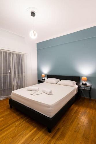 a bedroom with a large bed with white sheets at Central Elegant Flat in Patra