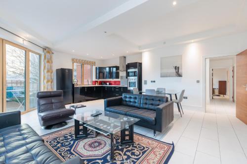 a living room with a couch and a table at Hestia Travel London in London
