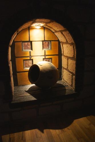a vase sitting in front of a brick archway at Aztic Hotel and Executive Suites in Mexico City