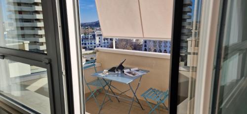 a balcony with a table and chairs and a window at LAMAR SUITES Seafront Apartments in Misano Adriatico