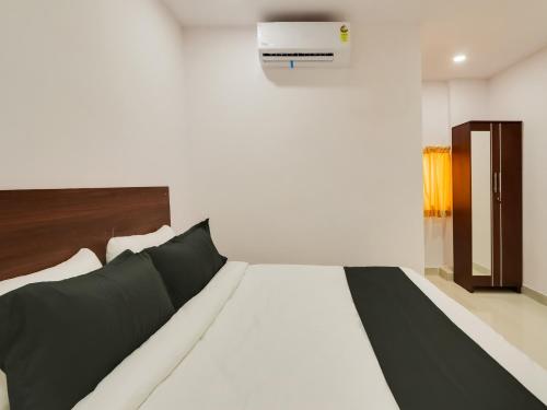 a bedroom with a bed and a air conditioner at Collection O HOTEL BEDS INN in Maula Ali