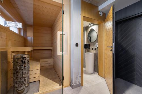 a sauna with a toilet and a glass door at Unique Apartment for 6 People in Zakopane with Access to Sauna by Renters in Zakopane