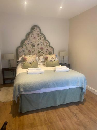 a bedroom with a large bed with two pillows at The Seagrave Arms in Weston Subedge
