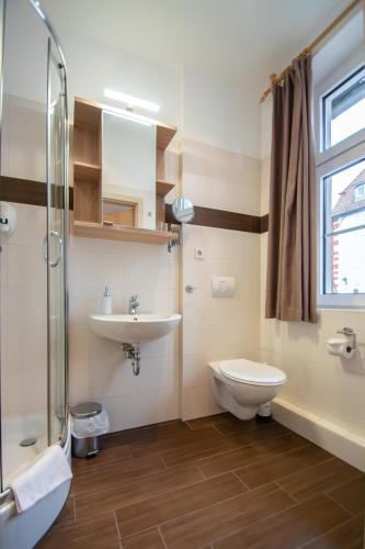 a bathroom with a sink and a toilet and a shower at Villa Altstadtperle Erfurt in Erfurt