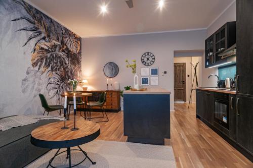 a kitchen and living room with a table and chairs at STING Boutique Apartments in Ostrava