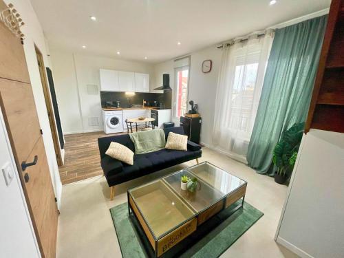 un salon avec un canapé et une table dans l'établissement Pleyel cosy, à Saint-Denis