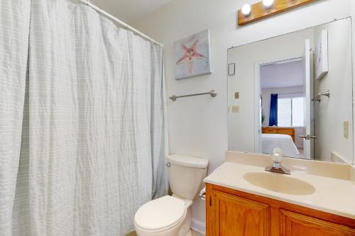 a bathroom with a toilet and a sink and a shower at Seven B Heaven in Rodanthe