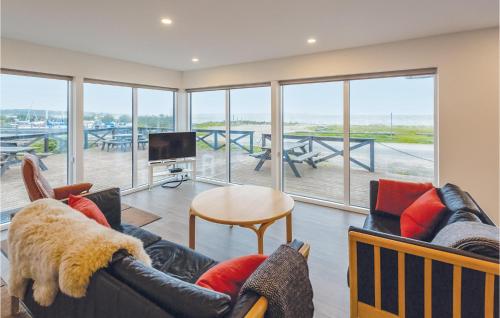 a living room with a couch and chairs and a television at Four-Bedroom Holiday Home In Brenderup Fyn in Vedelshave