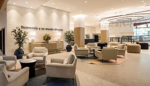 a waiting area with chairs and a waiting room at Ilunion Les Corts Spa in Barcelona