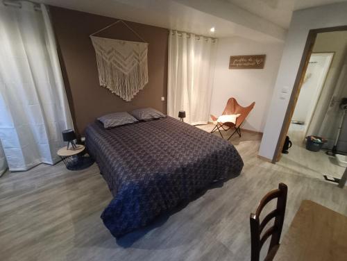 a bedroom with a bed and a table and chairs at Maison 4 chambres proche Etretat in Les Loges