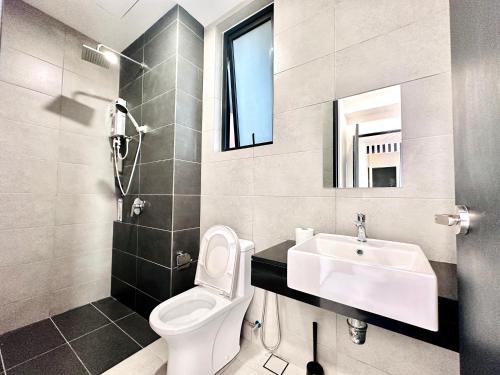 a bathroom with a white toilet and a sink at New 2BR or 3BR Homey Getaway stay 7 to 10 pax at Urban Suites, Georgetown by URBAN STAYCATION LOD in Jelutong
