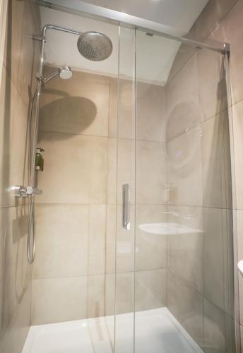 a shower with a glass door in a bathroom at Willowbeck Lodge Boutique Hotel in Carlisle