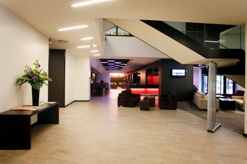 a lobby with couches and flowers in a building at Crowne Plaza Birmingham City, an IHG Hotel in Birmingham