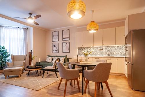 a kitchen and living room with a table and chairs at STING Boutique Apartments in Ostrava