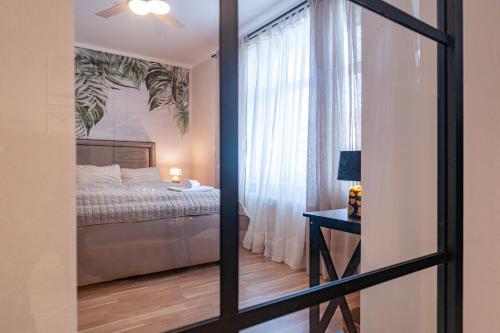 a bedroom with a bed and a window at STING Boutique Apartments in Ostrava