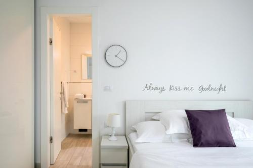 a bedroom with a bed and a clock on the wall at Korcula Luxury Apartments in Korčula
