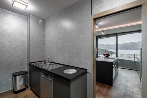 a bathroom with a sink and a washing machine at Korcula Luxury Apartments in Korčula
