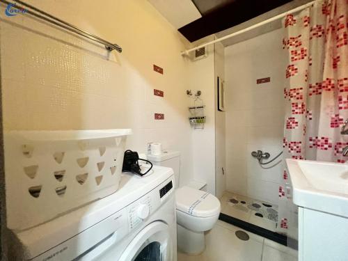 a bathroom with a washing machine and a toilet at Gtrip Monastiraki Cosy Apartment - 5026 in Athens