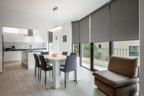 a kitchen and dining room with a table and chairs at Korcula Luxury Apartments in Korčula