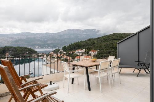 a table and chairs on a balcony with a view at Korcula Luxury Apartments in Korčula