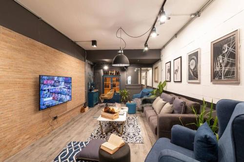 a living room with a couch and a tv at 4 Bedrooms House in Thapae/NightBazaar in Chiang Mai