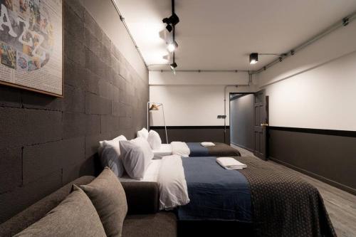 a bedroom with two beds and a wall at 4 Bedrooms House in Thapae/NightBazaar in Chiang Mai