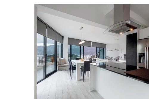 an open kitchen and dining room with a table and chairs at Korcula Luxury Apartments in Korčula