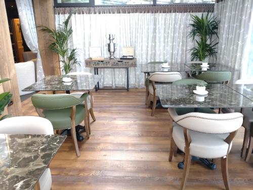 a dining room with tables and chairs and plants at Chalet BRAGARD in Limone Piemonte