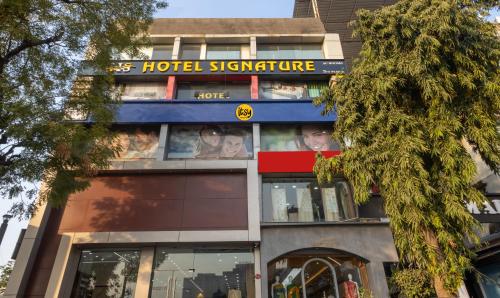 a building with a hotel signature sign on it at Itsy By Treebo - Signature, Nehru Nagar in Ahmedabad