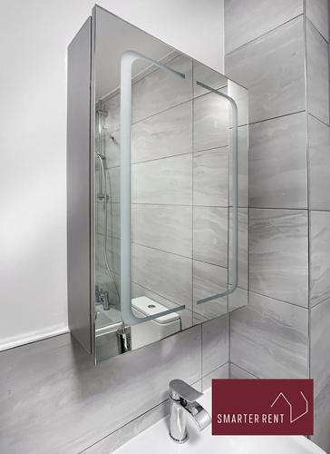 a bathroom with a sink and a mirror on the wall at Knaphill - 2 Bedroom Terrace House - With Garden in Brookwood