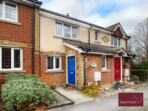 a brick house with blue and red doors at Knaphill - 2 Bedroom Terrace House - With Garden in Brookwood