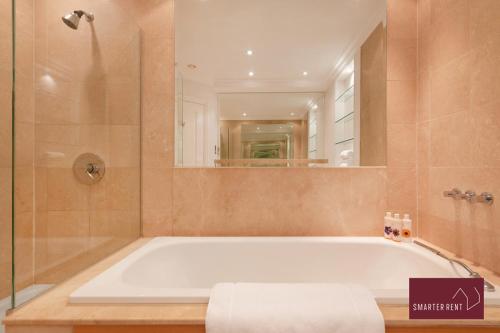 a large bathroom with a tub and a shower at Richmond - 5 Bedroom Townhouse with Parking & Garden in London