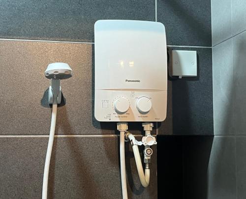 a hair dryer is plugged into a wall at Family friendly 3 bedroom 8-10pax @Urban Suites in George Town