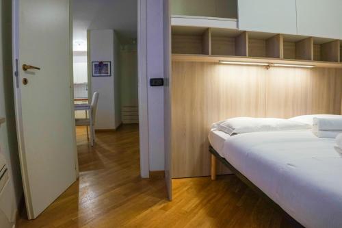 a bedroom with two beds and a room with a table at Italianflat - Filippini Apartment in Verona