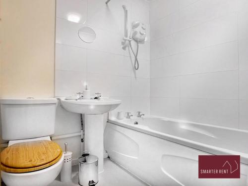 a bathroom with a toilet and a sink and a tub at Lightwater - One Bedroom House - With Parking in Bagshot
